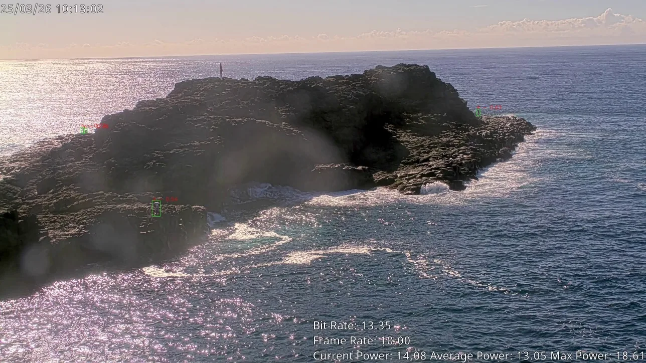 A SAIL camera view of a rock platform with coloured detection annotations, sun glare and marks on the lens.